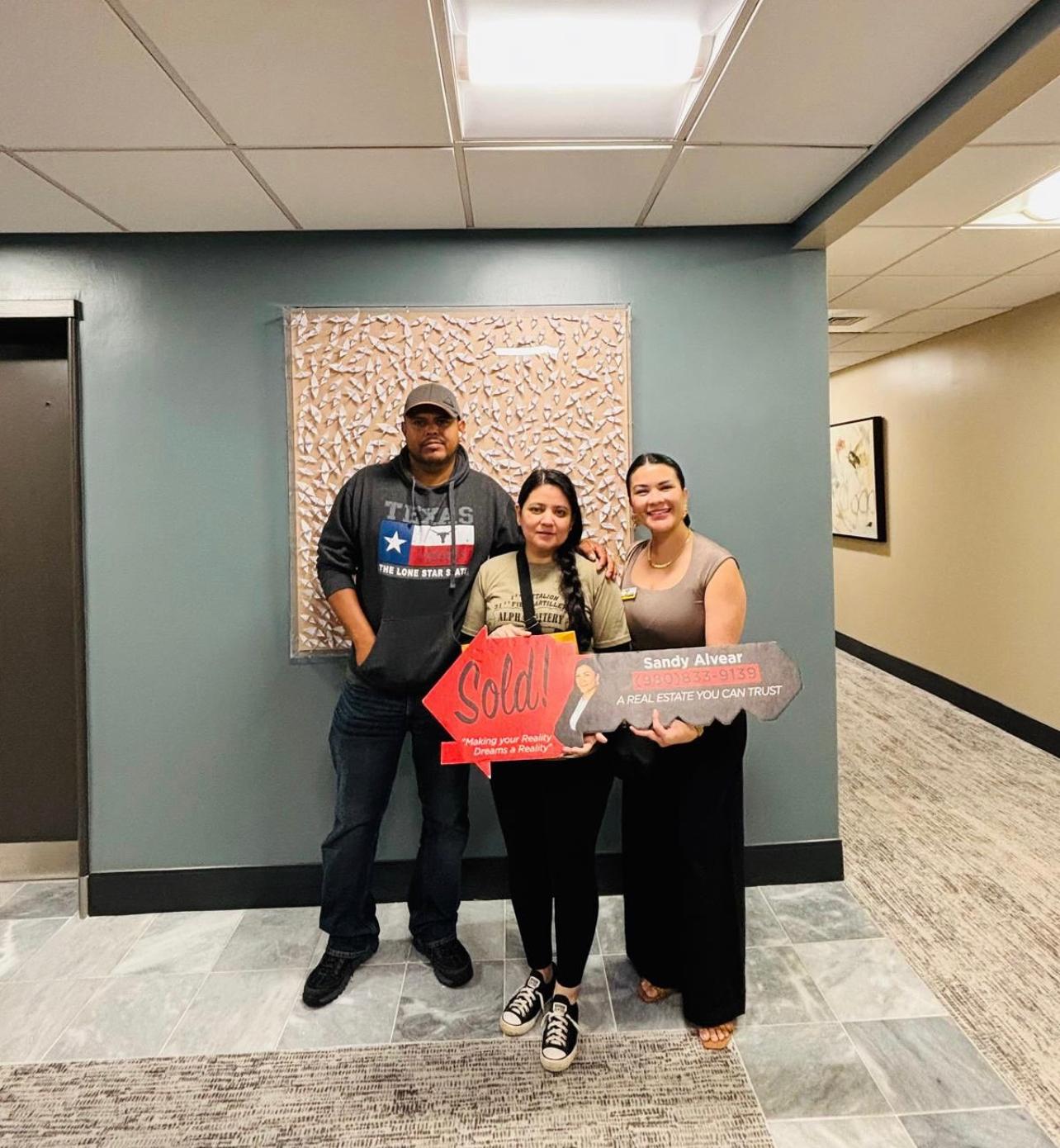Sandy Alvear with clients outside sold home Belmont NC